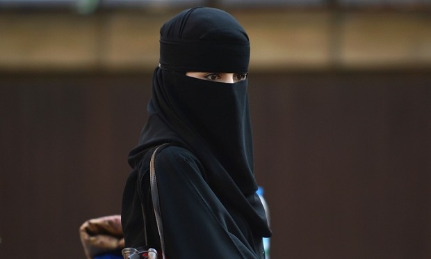 A Muslim woman looks on after attending prayers at the Regent's Park Mosque in London on August 19, 2012. Muslims around the world celebrate Eid al-Fitr, marking the end of Ramadan, the Muslim calendar's ninth and holiest month during which followers are required to abstain from food, drink and sex from dawn to dusk. AFP PHOTO / ADEK BERRY