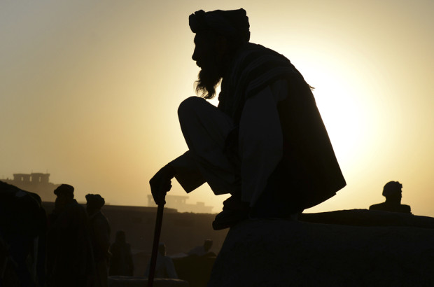An Afghan trader waits for customers early in the morning at a livestock market ahead of the sacrificial Eid al-Adha festival in Kabul on October 2, 2014. Muslims across the world are preparing to celebrate the annual festival of Eid al-Adha, or the Festival of Sacrifice, which marks the end of the Hajj pilgrimage to Mecca and commemorates Prophet Abraham's readiness to sacrifice his son to show obedience to God. AFP PHOTO/SHAH Marai