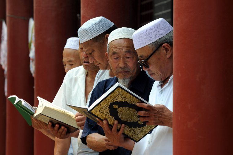 This picture taken on June 30, 2014 shows Chinese Muslims reading the Koran at a mosque in Tancheng, in eastern China's Shandong province, at the beginning of the holy month of Ramadan. Across the Muslim world, the faithful fast from dawn to dusk, and abstain from eating, drinking, smoking and having sex during that time as they strive to be more pious and charitable. CHINA OUT AFP PHOTO