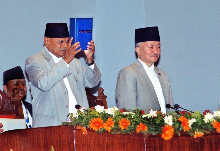 President Ram Baran Yadav promulgating Nepal’s Constitution after signing the copies of the constitution authenticated by CA Chairman Subas Chandra Nembang during a special function at the Constituent Assembly Hall on Sunday. Photo: Dhruba Ale/ THT