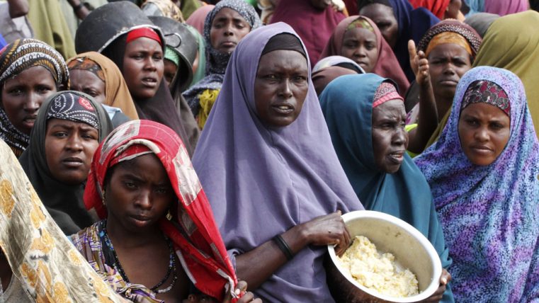 Internally displaced Somali women wait for food at a camp in the capital Mogadishu